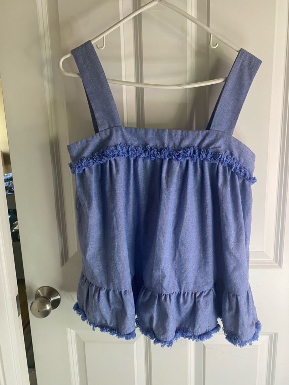 Entro blue swing top with grey stripes and a ruffled hem.